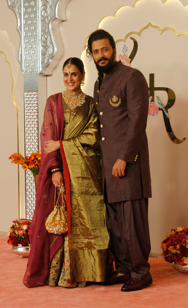 Genelia D'Souza and Riteish Deshmukh on the red carpet. Genelia wears a traditional saree, and Riteish wears a dark sherwani