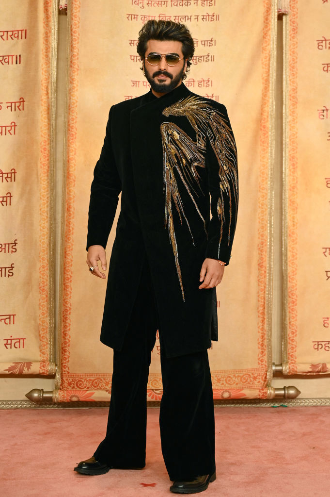 Arjun Kapoor on the red carpet, wearing a traditional outfit with embroidery and sunglasses