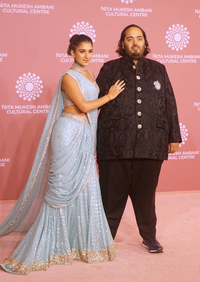 Radhika Merchant, in a glittering saree with a sheer drape, and Anant Ambani, in an ornate sherwani, at the Nita Mukesh Ambani Cultural Centre event