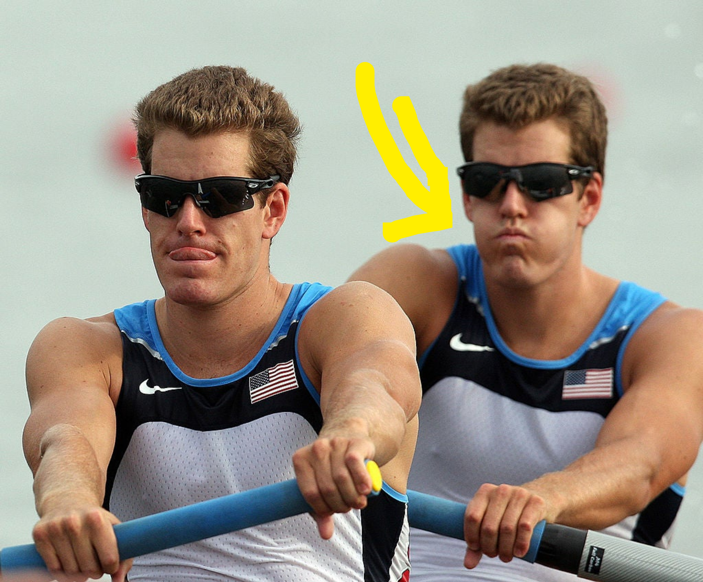 Tyler and Cameron rowing, wearing sleeveless athletic tops with the USA flag and sunglasses