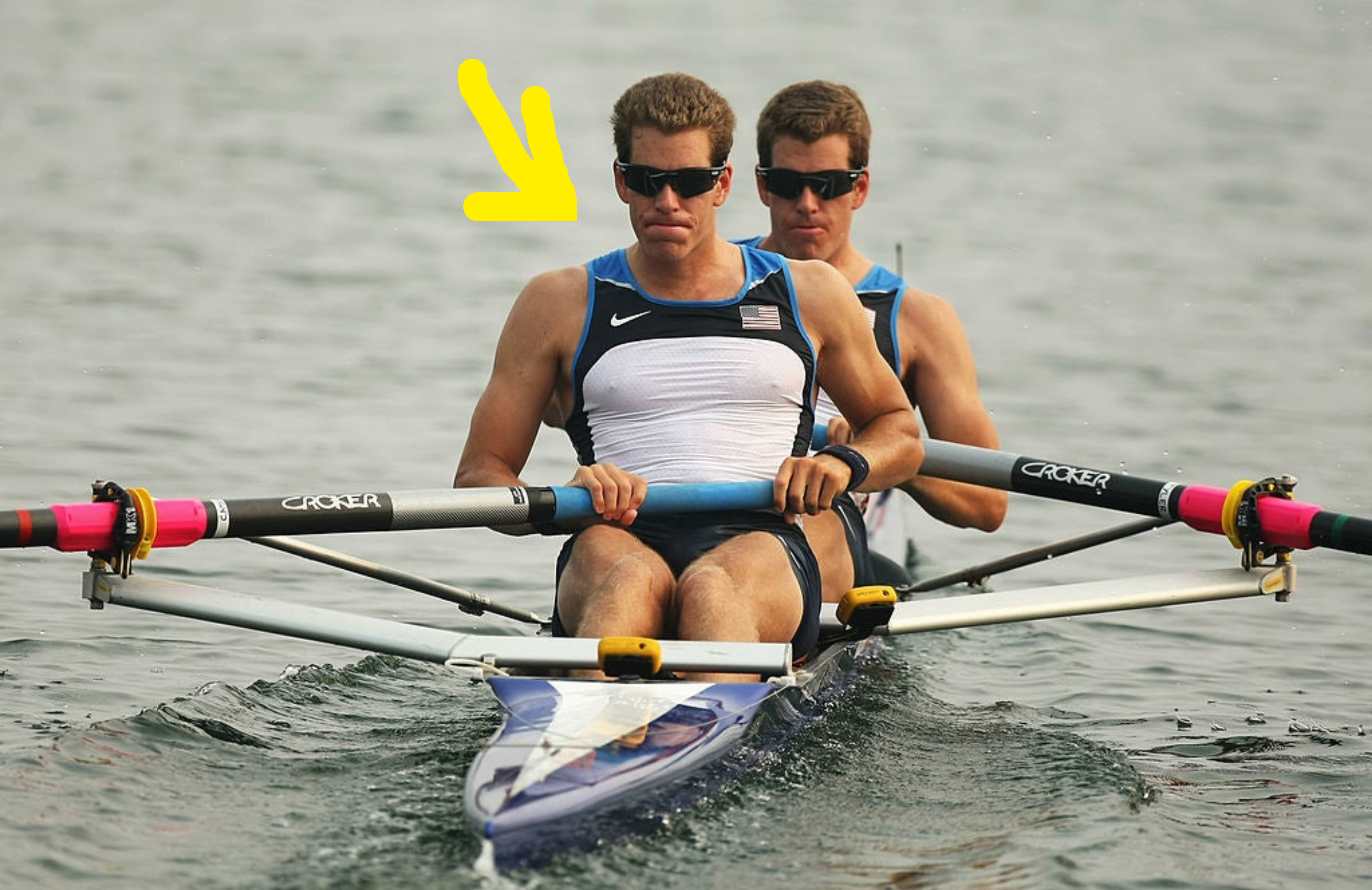 Tyler Winklevoss and Cameron Winklevoss rowing together in a race, wearing athletic rowing attire and sunglasses