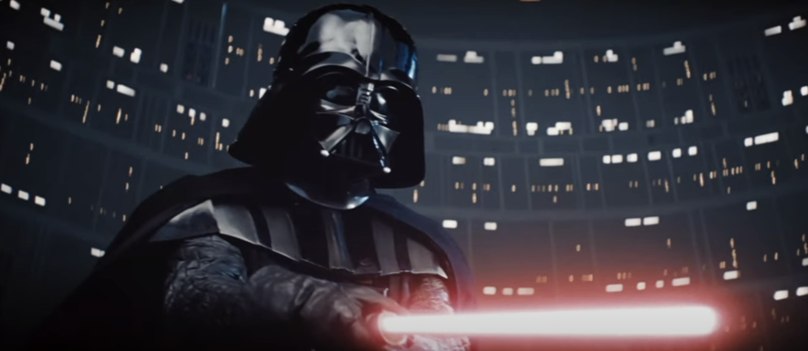Darth Vader wielding a lightsaber in a futuristic setting with numerous lights in the background