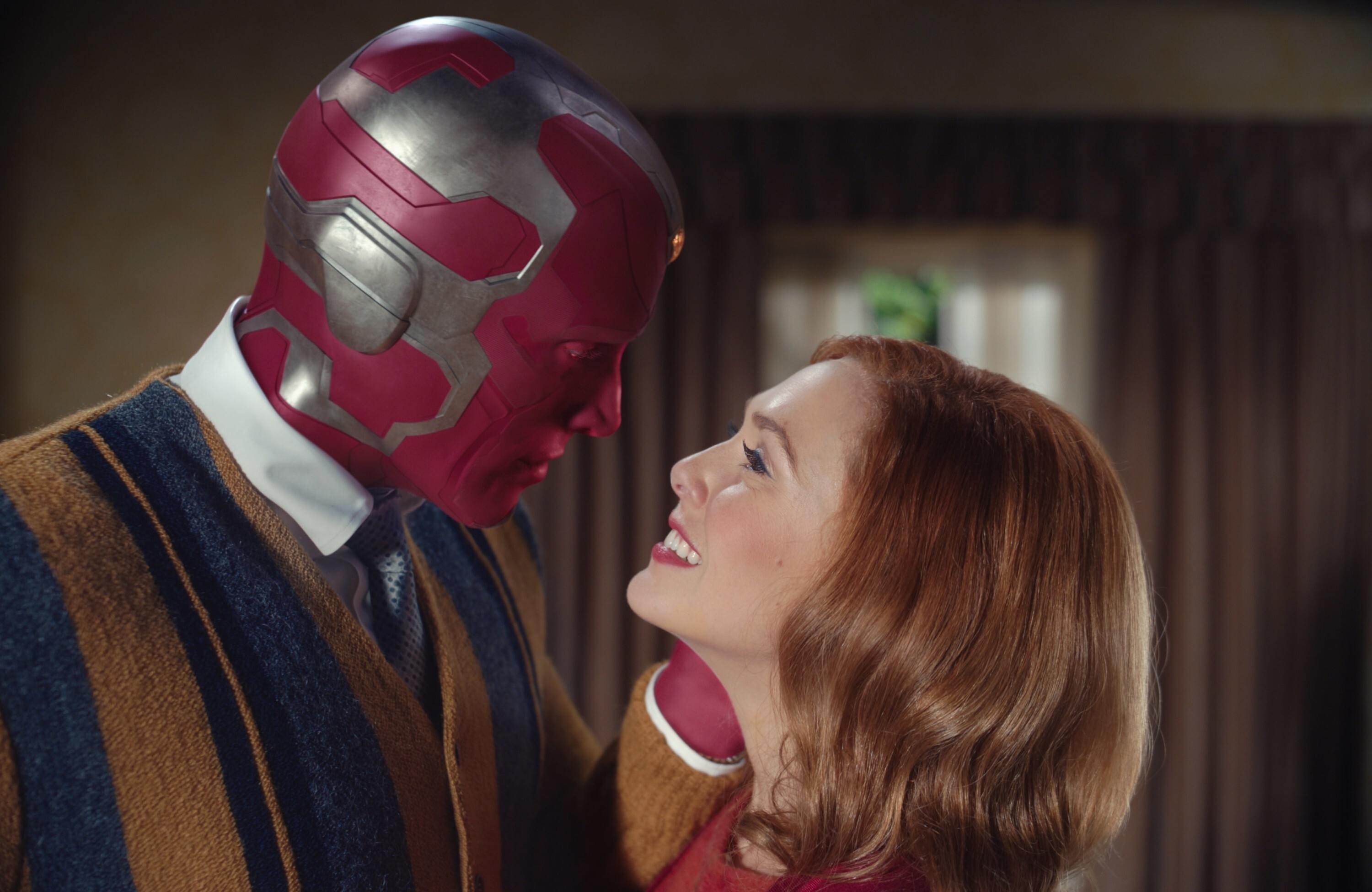 Paul Bettany as Vision and Elizabeth Olsen as Wanda Maximoff share a tender moment, looking at each other closely in a scene from "WandaVision"