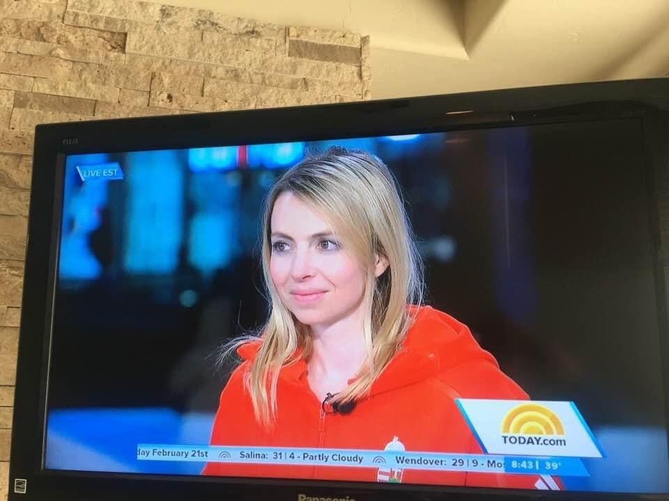 Elizabeth is wearing her Hungarian team jacket and is being interviewed on the TODAY show. She is smiling and looking forward