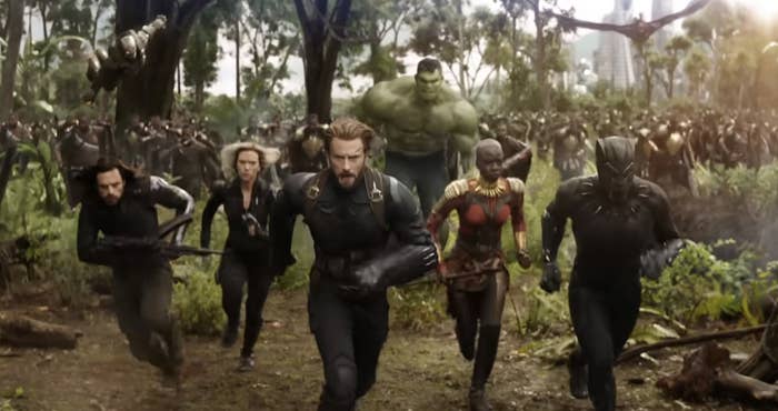 Bucky Barnes, Black Widow, Captain America, Okoye, Hulk, and Black Panther charge forward in a battle scene from an "Avengers" movie