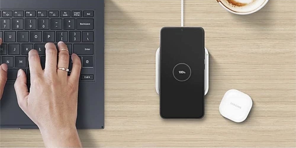 Wireless charger is shown in use with a smartphone on a desk, alongside a laptop and wireless earbuds. Text highlights its slim, compact design for small spaces