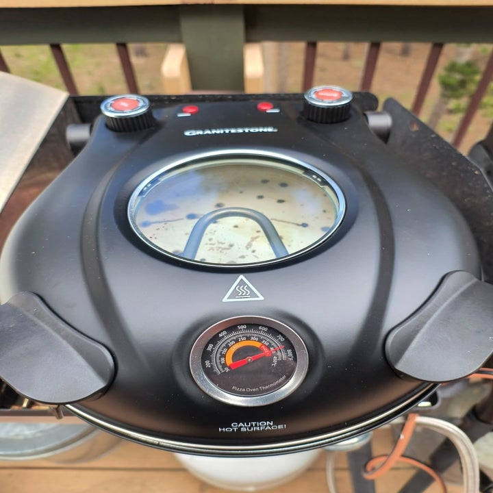 Close-up of a black Granitestone grill with a built-in thermometer and dials