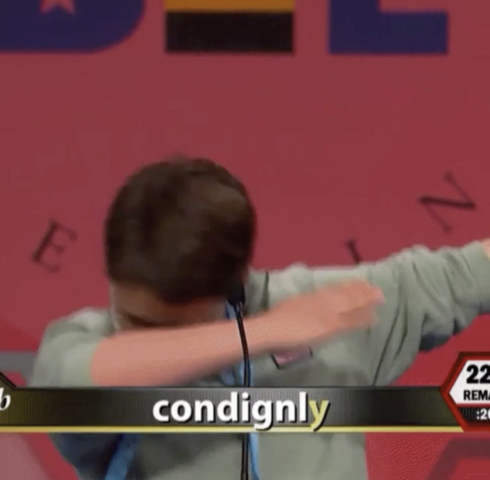 A boy on stage dabs after spelling the word &quot;condignly&quot; during a spelling bee