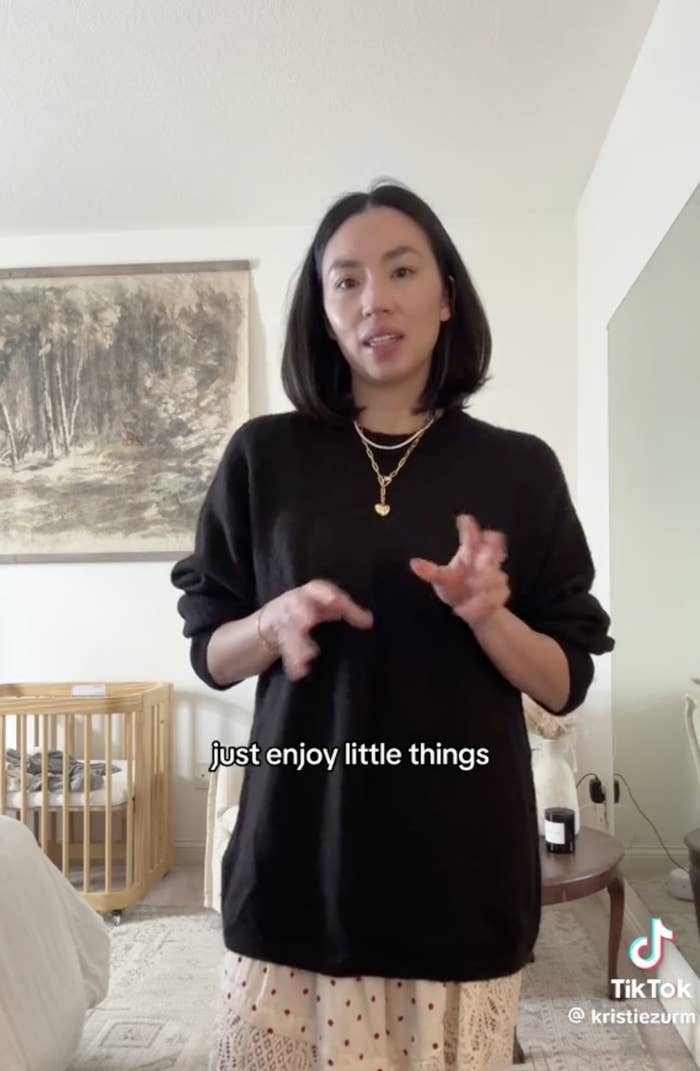 Kristie stands in a room with a crib behind her. The text in the image reads, just enjoy little things