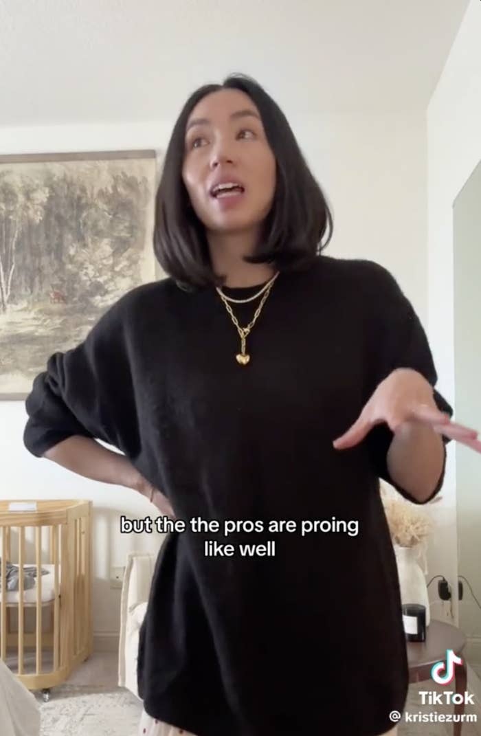 Kristie stands in a room talking, The subtitles read, but the pros are proing