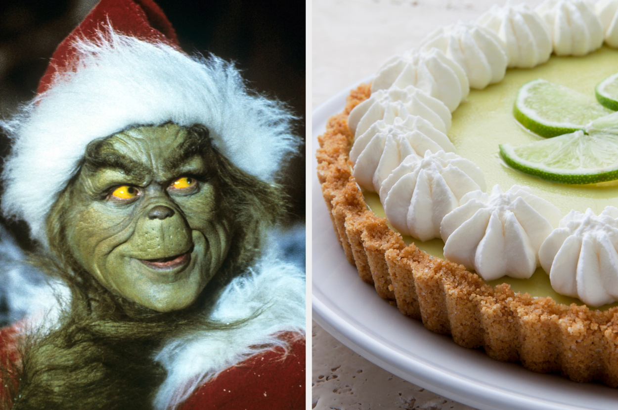 The Grinch dressed in a Santa outfit next to a key lime pie garnished with whipped cream and lime slices