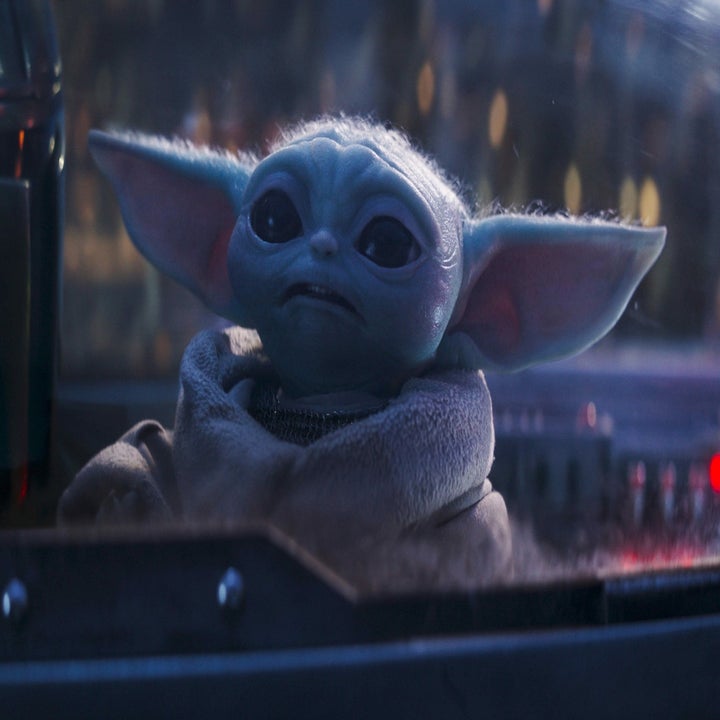 Grogu (Baby Yoda) appears inside a spacecraft, looking outside with a curious expression. The character is from the series The Mandalorian