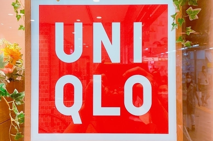 UNIQLO store sign decorated with flowers and greenery
