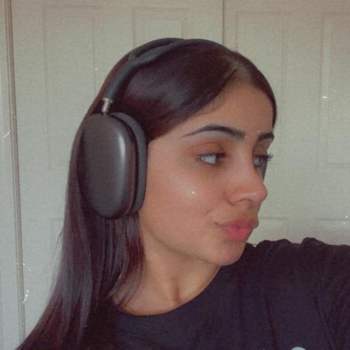 Reviewer wearing the black AirPods Max over-ear headphones