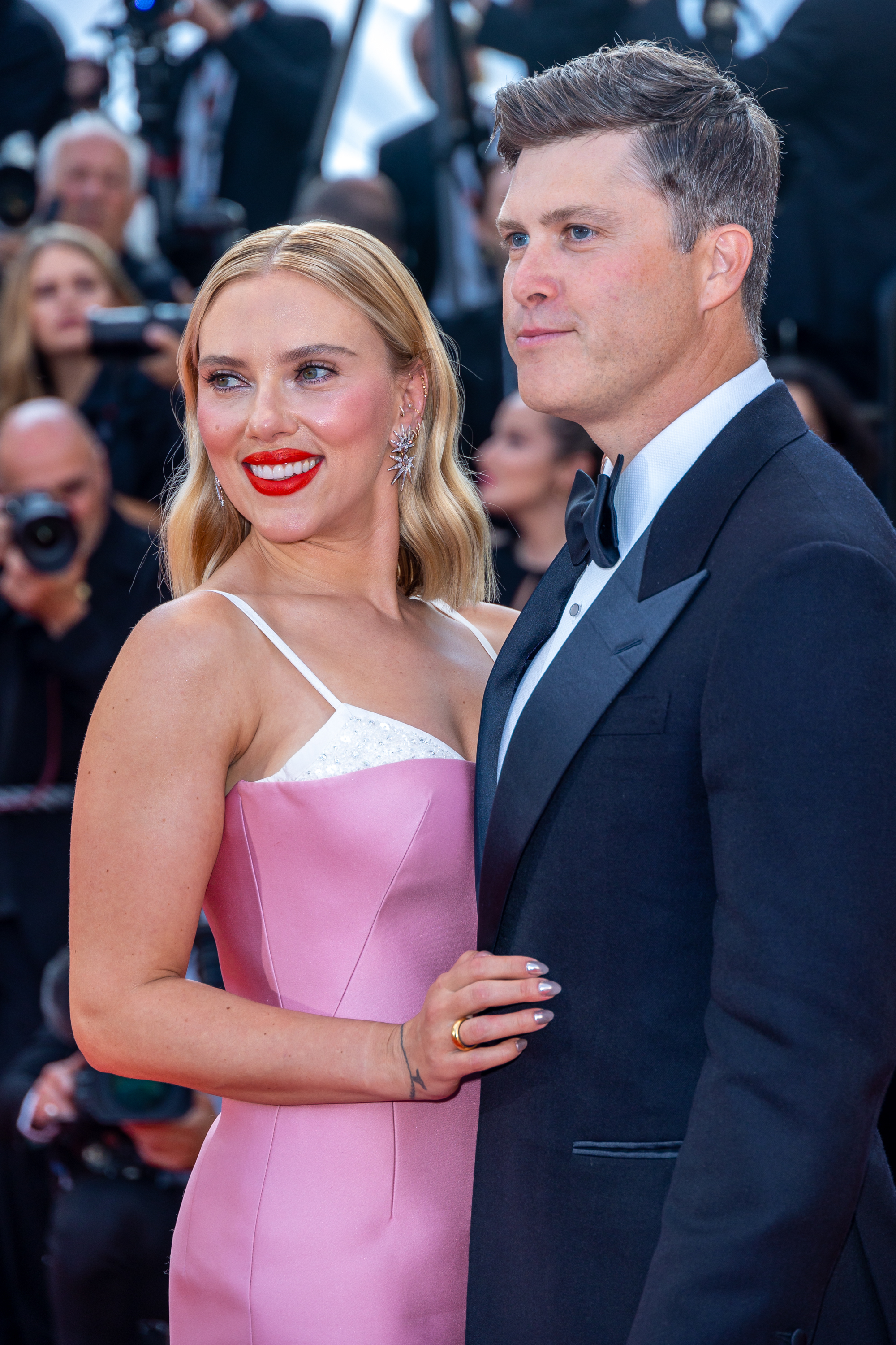 Scarlett Johansson in a strapless gown and Colin Jost in a tuxedo pose together at a formal event