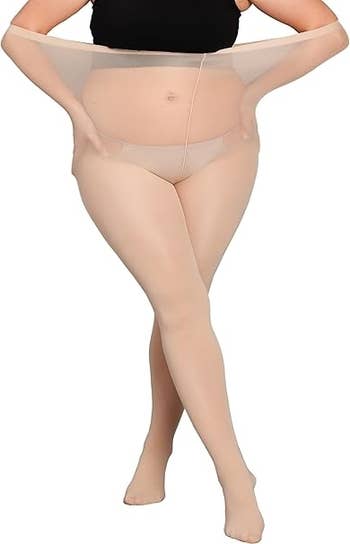 Person demonstrating stretchy, high-waisted, sheer beige pantyhose against a plain background. No different notable elements successful the image