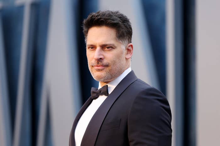 Joe Manganiello at a red carpet event, wearing a black tuxedo with a bow tie