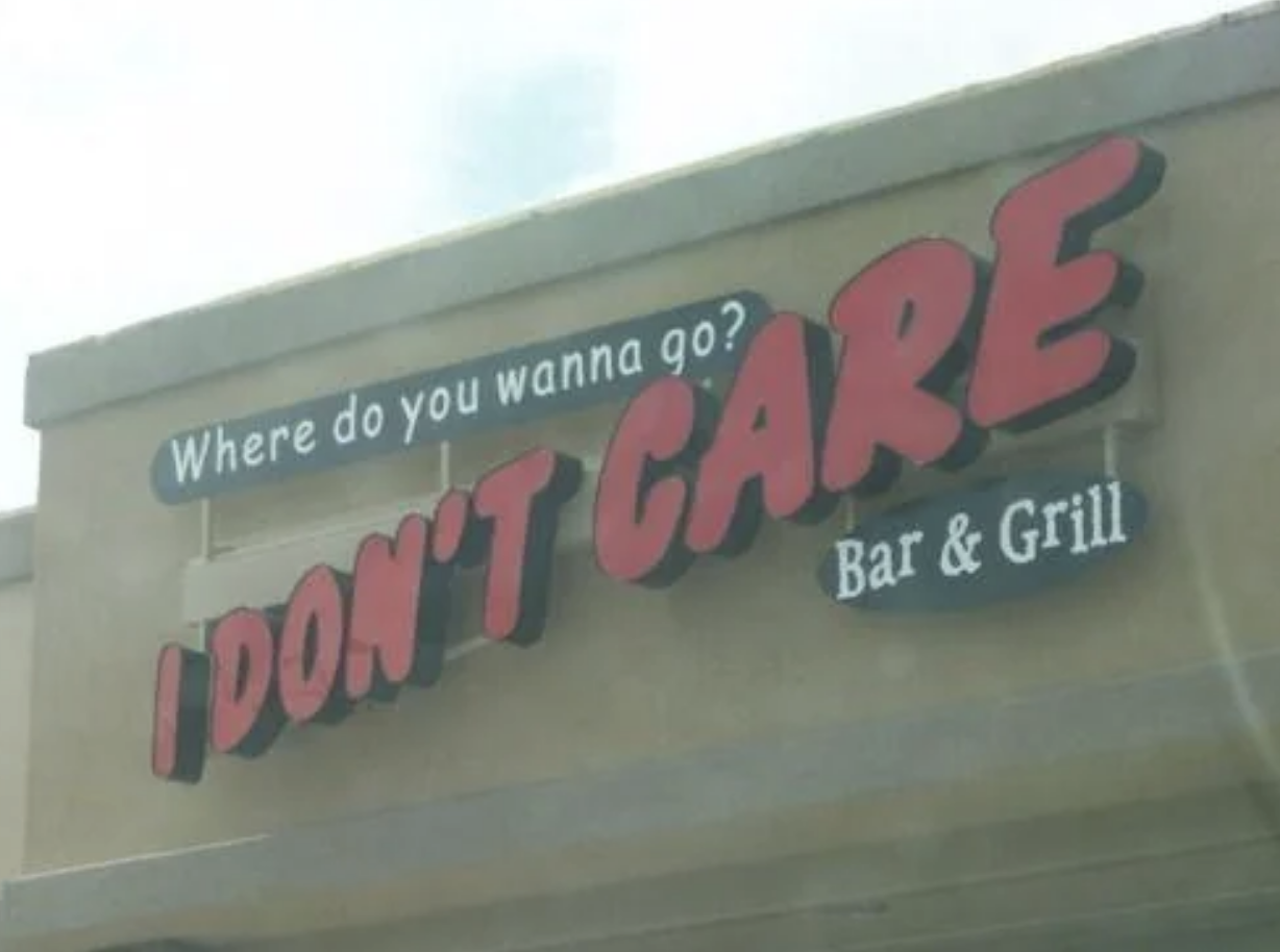 Sign for "I Don't Care Bar & Grill" with the phrase "Where do you wanna go?" above it