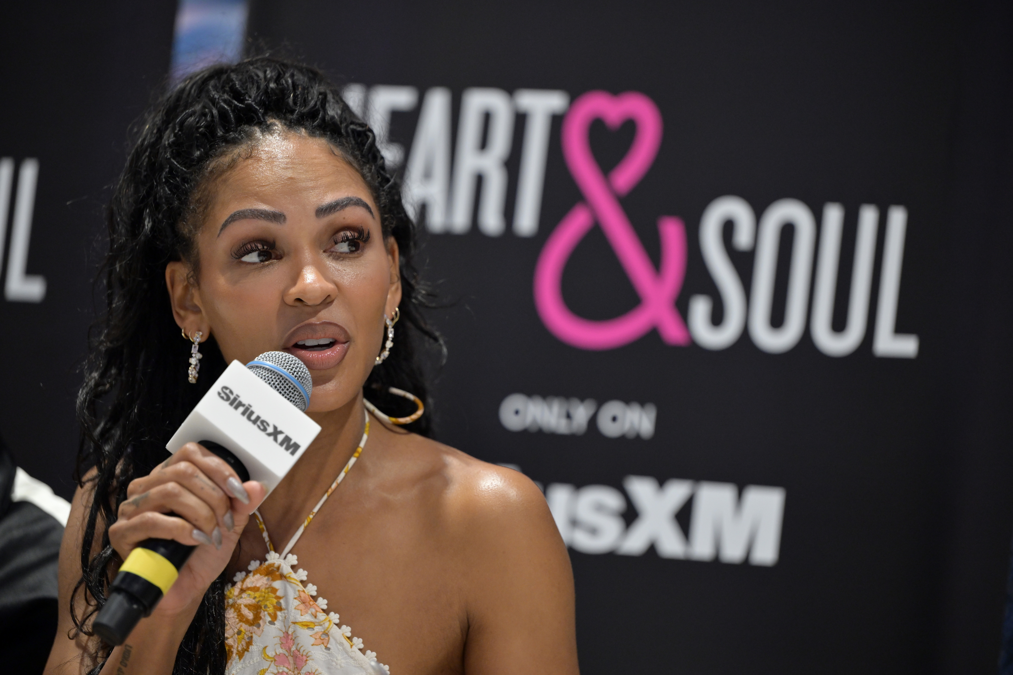 Meagan Good speaking into a microphone at a SiriusXM event promoting &quot;Heart &amp;amp; Soul&quot; radio channel