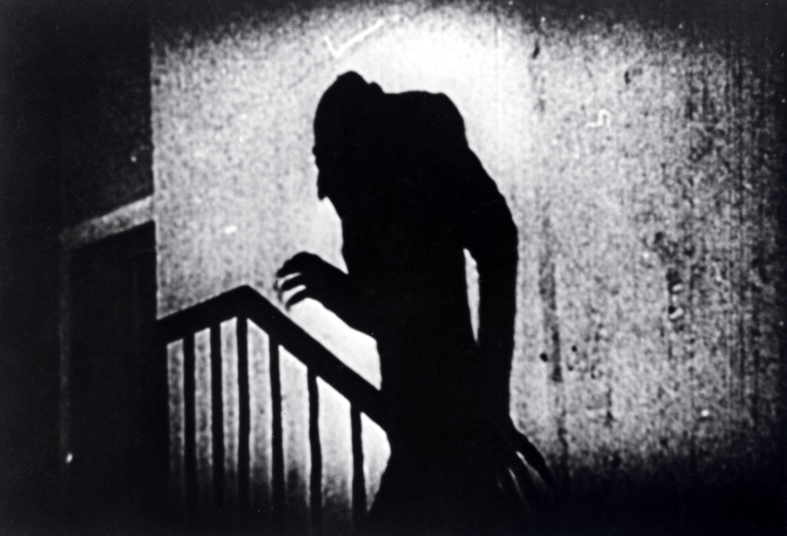 The silhouette of Nosferatu creeping up a staircase