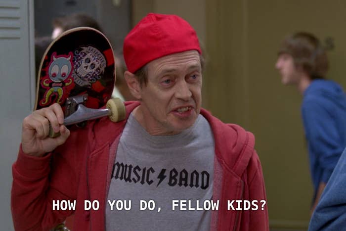 Steve Buscemi, dressed in a backward red cap, red hoodie, and "Music Band" t-shirt, holds a skateboard, saying, "How do you do, fellow kids?"