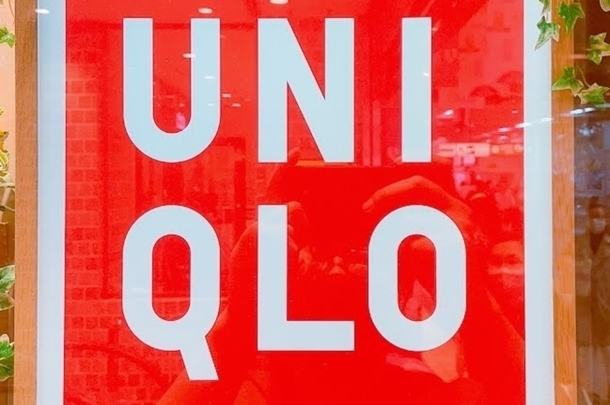 UNIQLO store sign decorated with greenery and flowers hanging on the sides