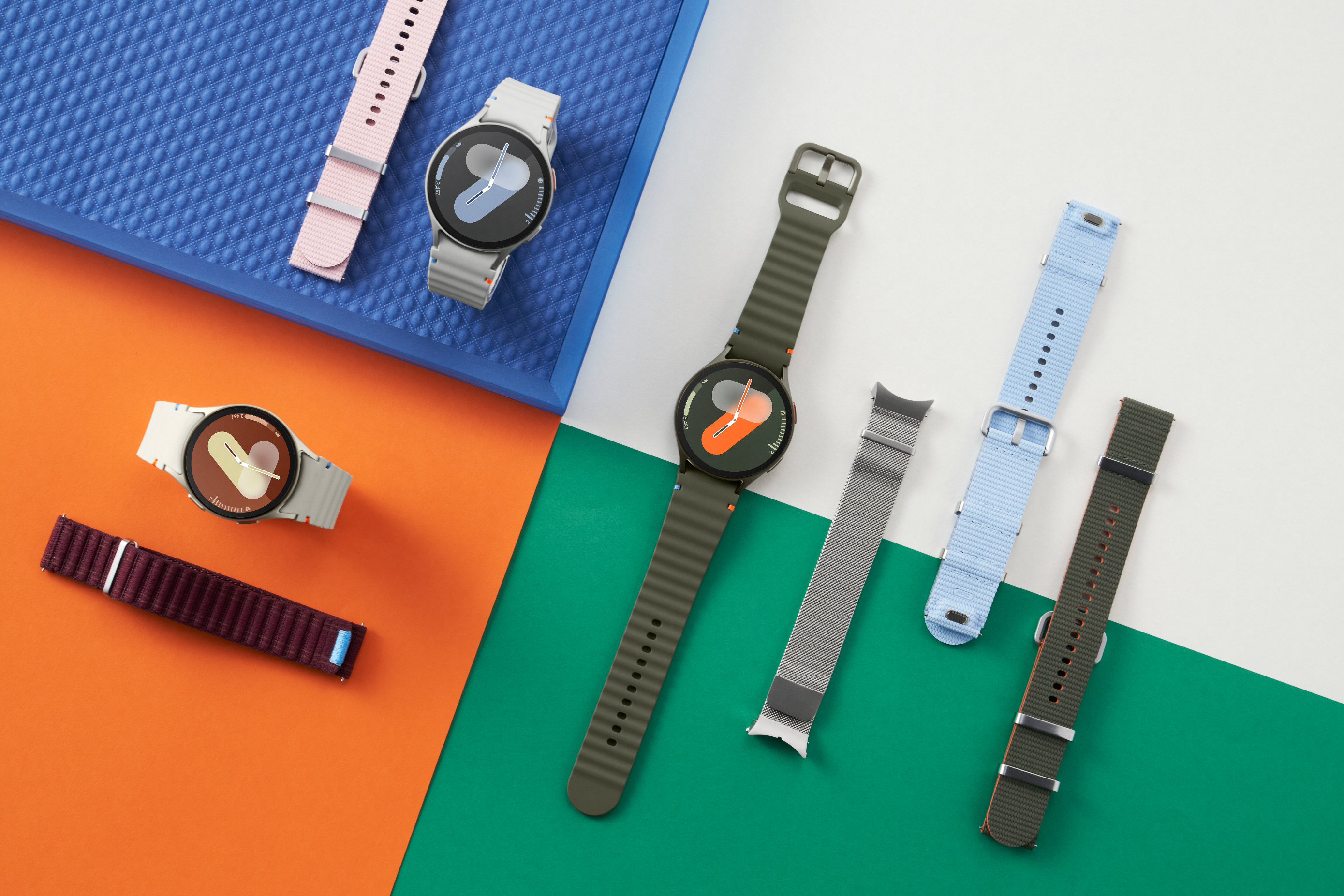Several stylish smartwatches and interchangeable wristbands are displayed on a colorful background