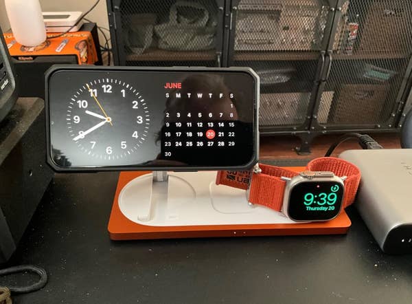 Digital clock showing time and calendar for June, with an Apple Watch on a charging stand displaying 9:39 on Thursday the 20th