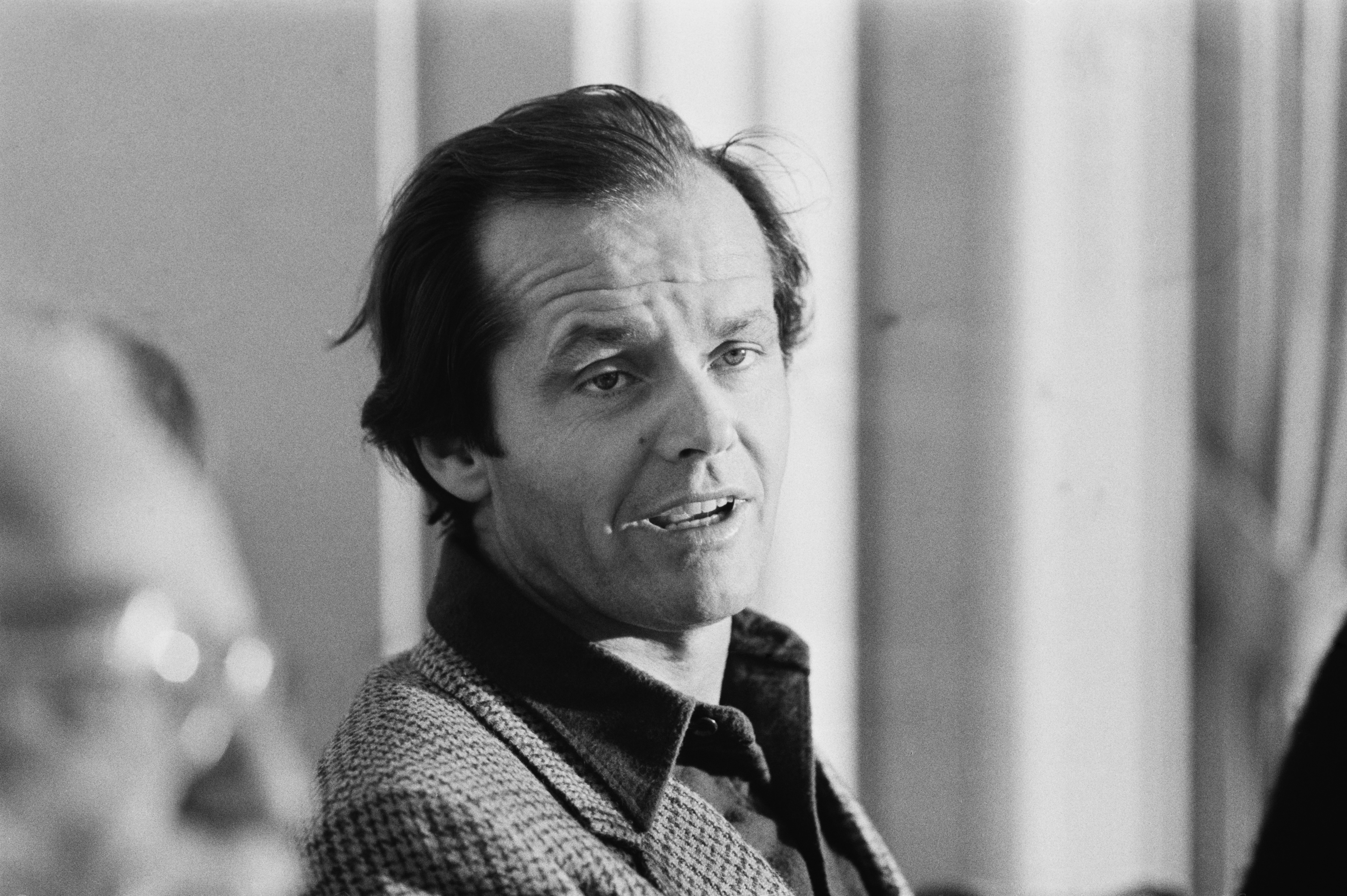 Jack Nicholson in a candid moment, dressed in a casual jacket and shirt, speaking