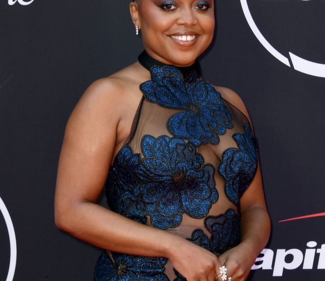 Quinta Brunson poses on the red carpet in a floral-patterned gown at the ESPY Awards