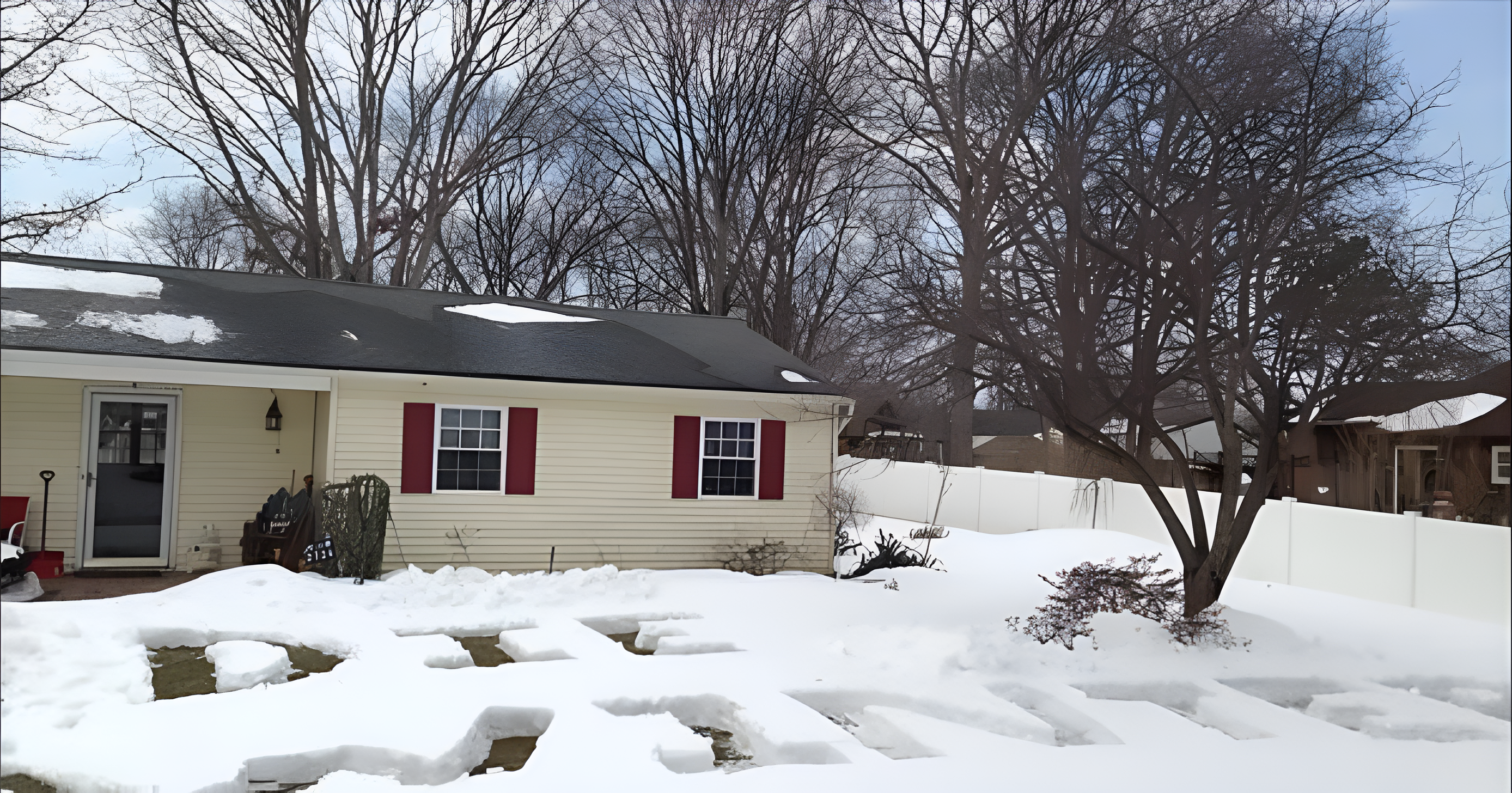 A house with snow on the ground in front spelling out "DIE WINTER" in large letters