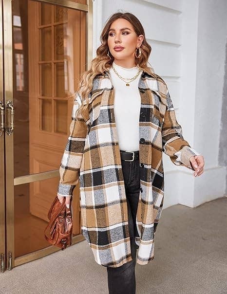 A exemplary wearing a plaid agelong coat, achromatic top, and achromatic jeans holds a brownish leather bag, lasting successful beforehand of a doorway, looking to her left