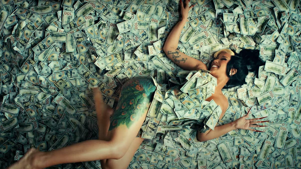 In the new song's video, Cardi delivers her verse from atop a pile of cash.