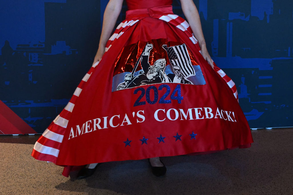 A woman in a dress adorned with American flag motifs shows the year &quot;2024&quot; and &quot;America's Comeback!&quot;