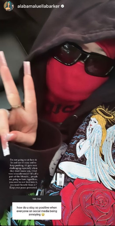 Alabama Luella Barker in a hoodie and sunglasses, wearing a red face mask, showing a peace sign. Text advises on dealing with social media negativity