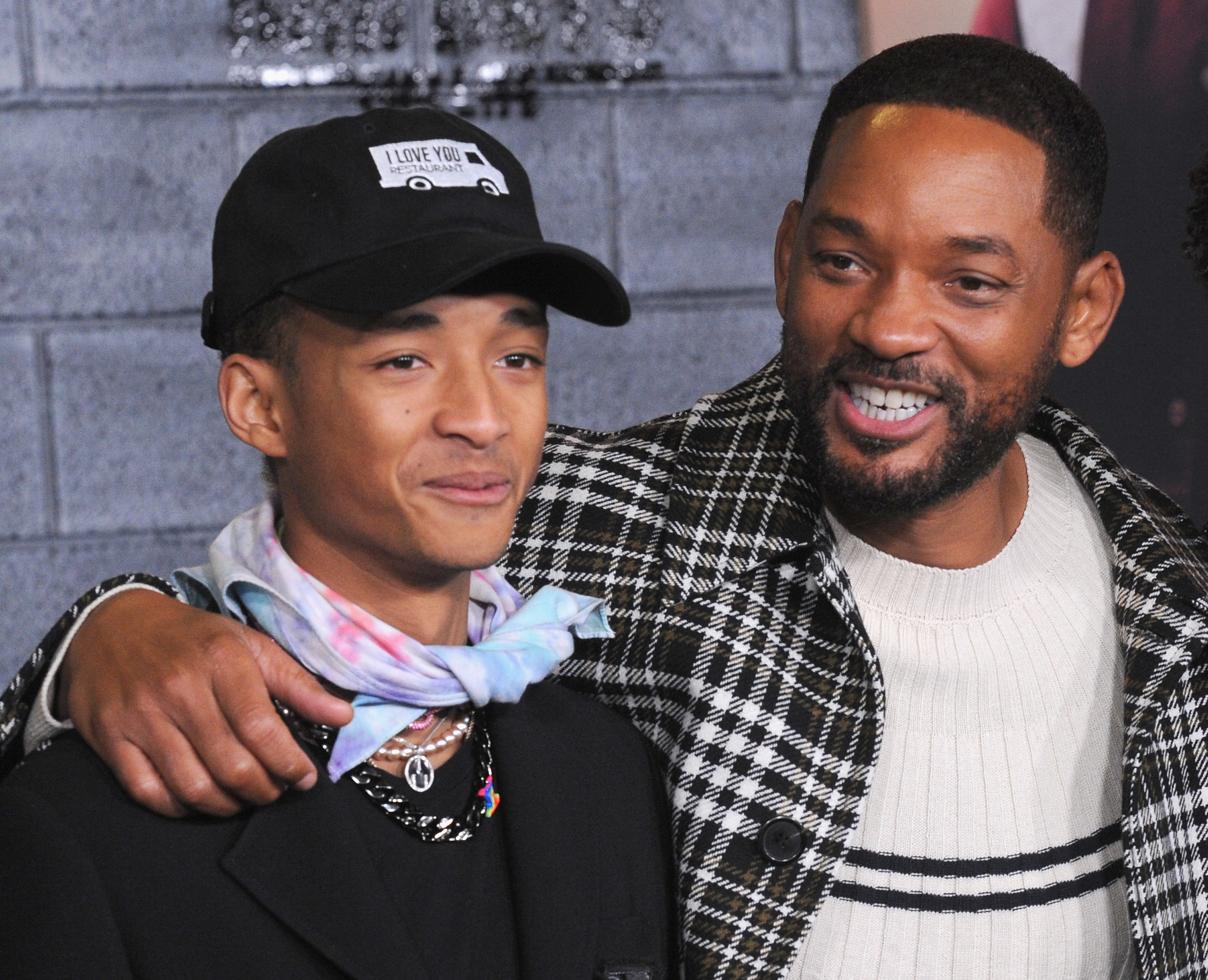 Jaden Smith and Will Smith pose together, smiling.