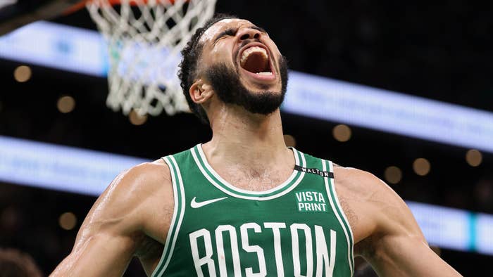 Basketball player wearing a Boston Celtics jersey passionately celebrates during a game