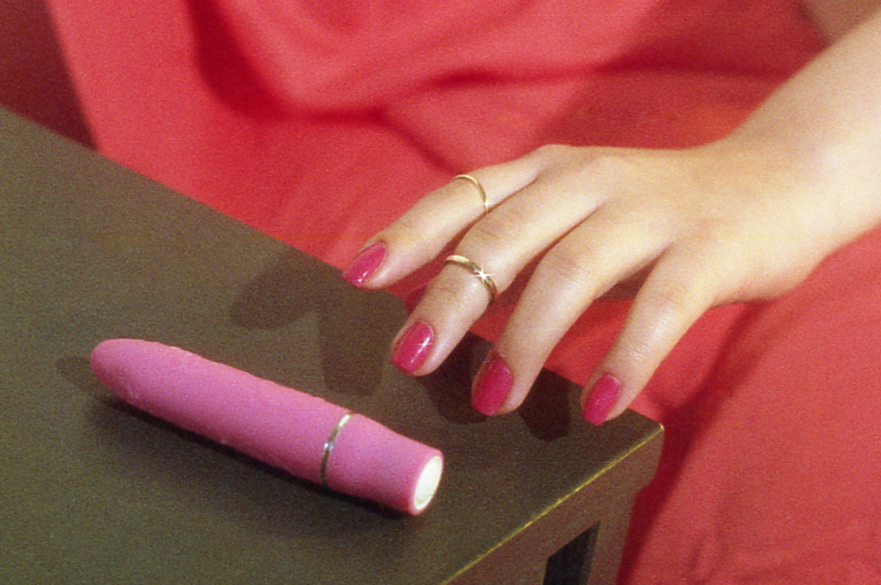 Woman reaching for vibrator