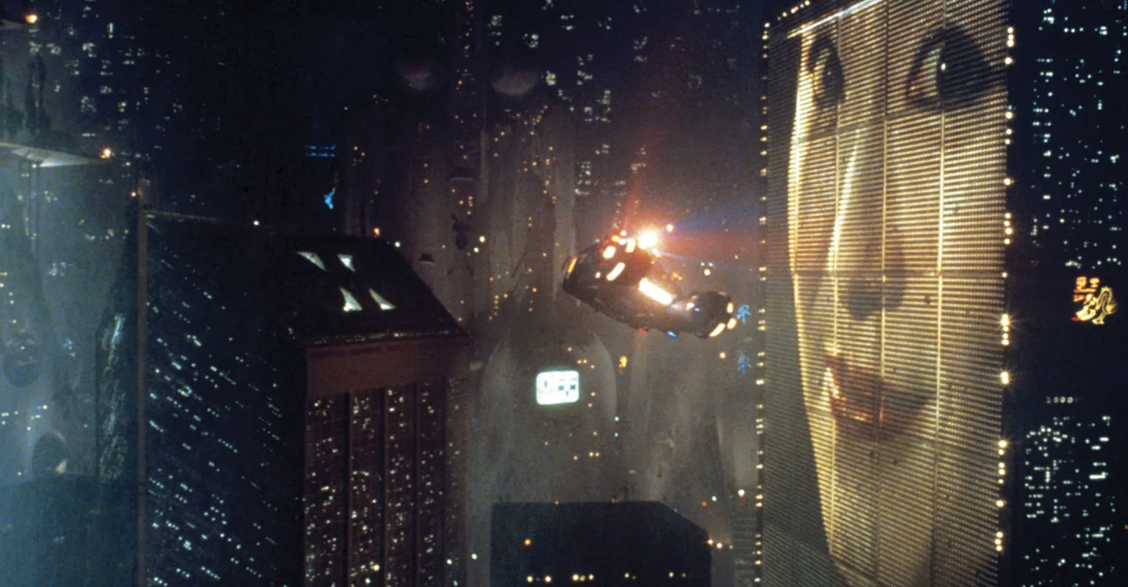 A flying car navigates through a futuristic cityscape with a large digital billboard displaying an Asian woman's face