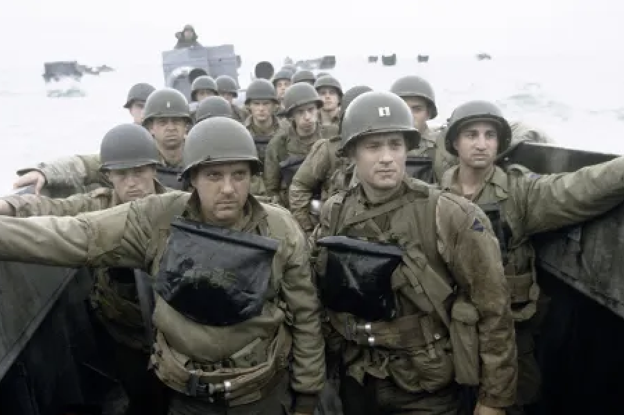 Soldiers on a boat in WWII military gear with life vests, likely depicting a historical scene of a beach landing