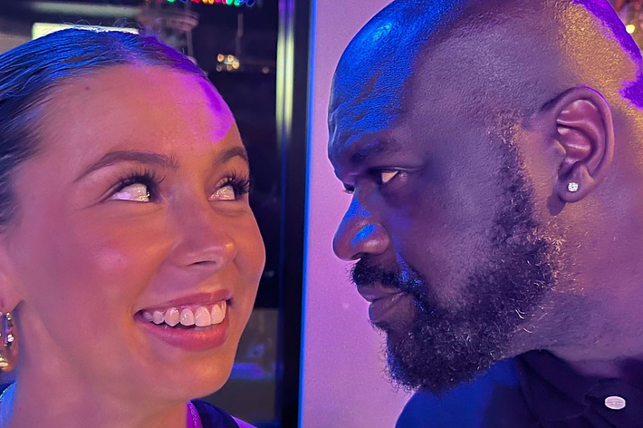 Shaquille O'Neal and Hawk Tuah star share a close, smiling moment, both dressed casually