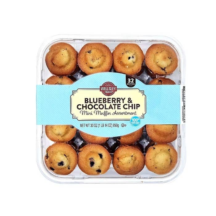 Plastic container with 32 mini muffins, labeled "Wellsley Farms Blueberry & Chocolate Chip Mini Muffin Assortment."