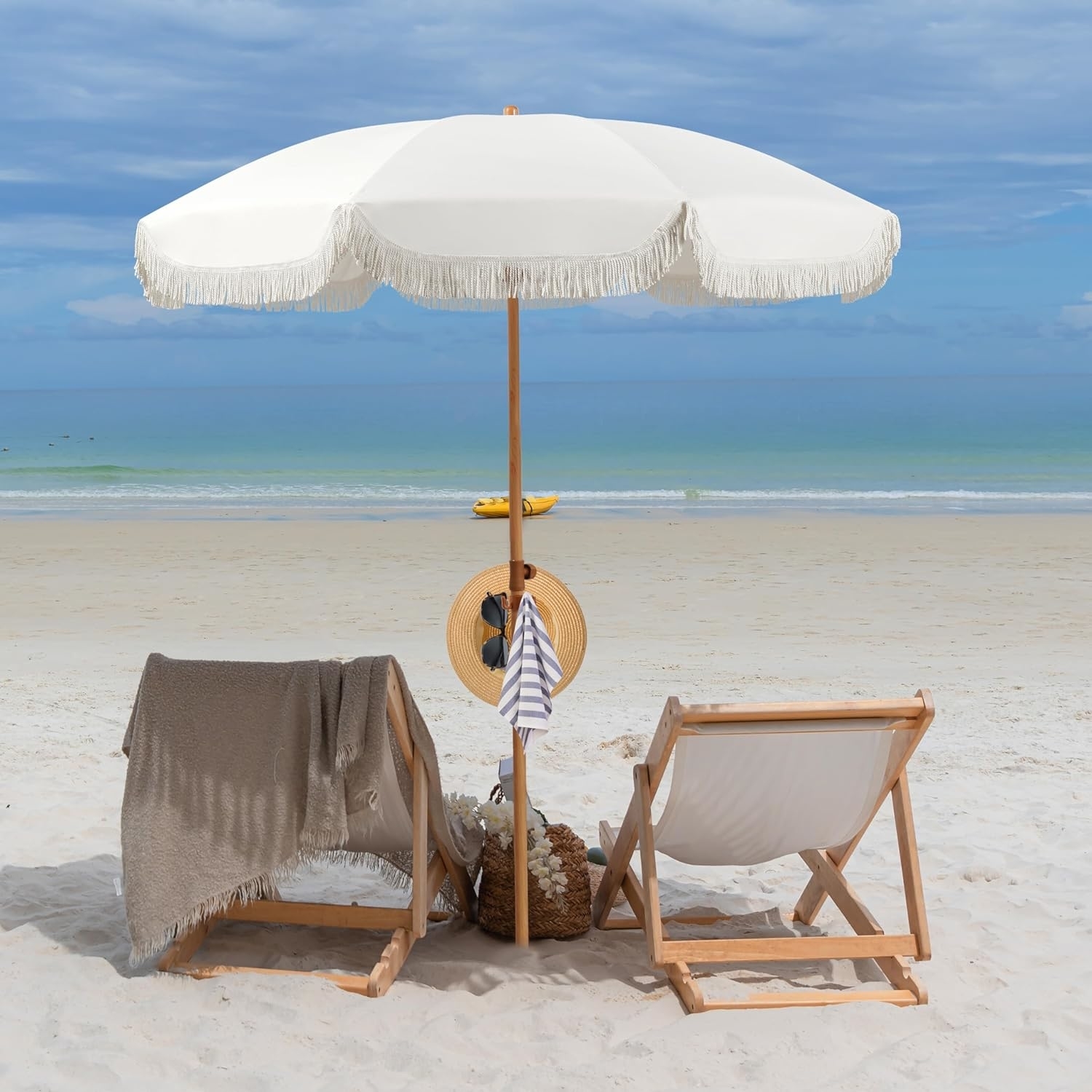 The elegant cream umbrella between two beach chairs