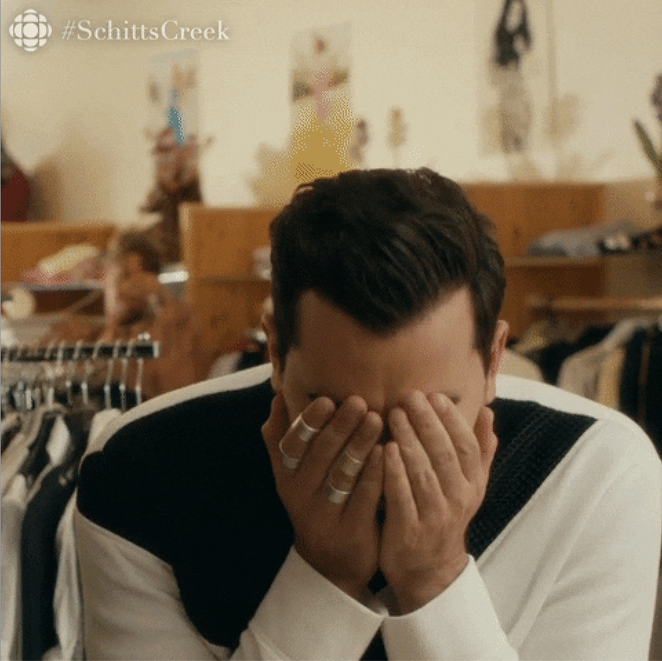 David Rose from Schitt's Creek covers his face with his hands in distress