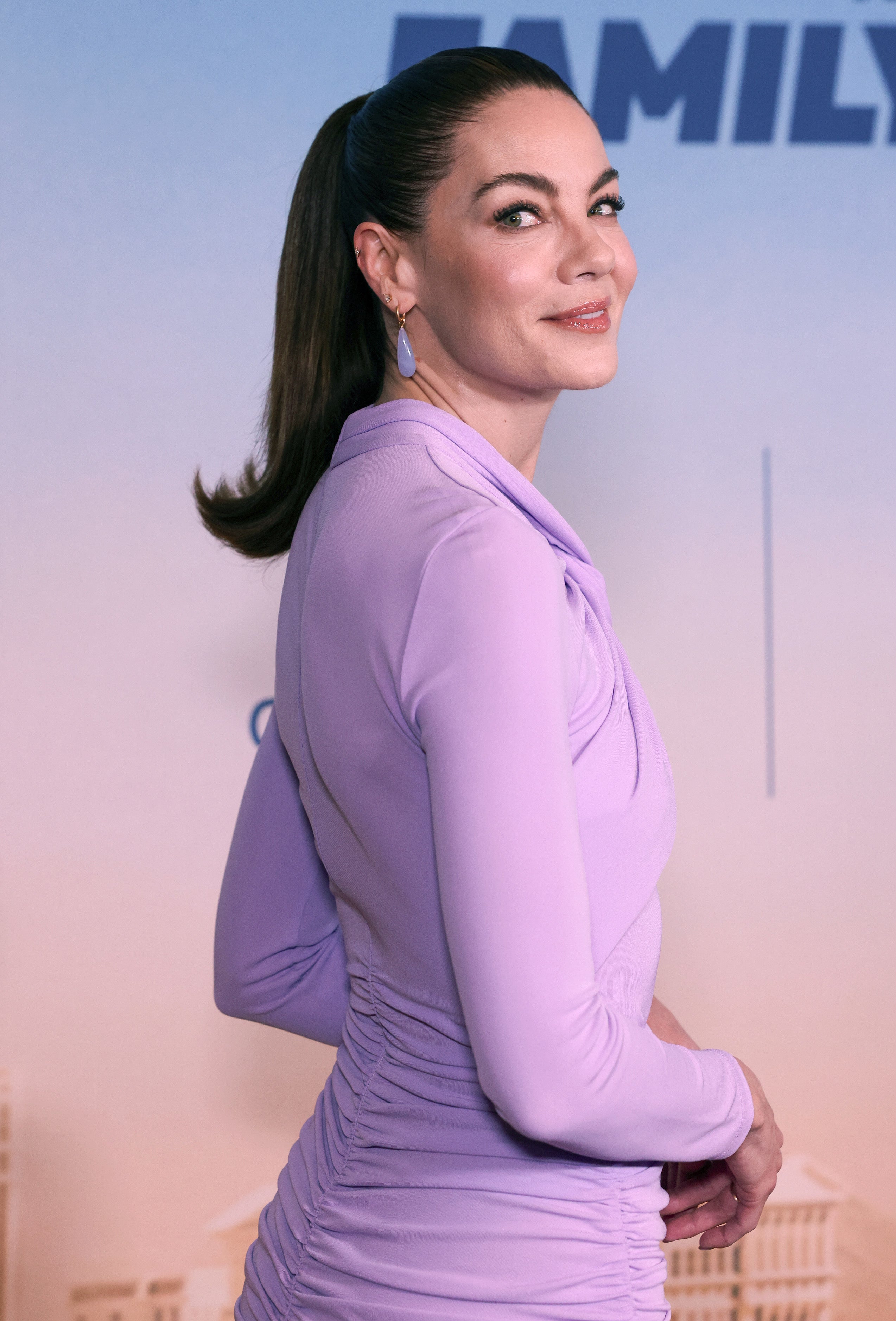 Michelle Monaghan in a lavender dress at the premiere of "The Family Plan"