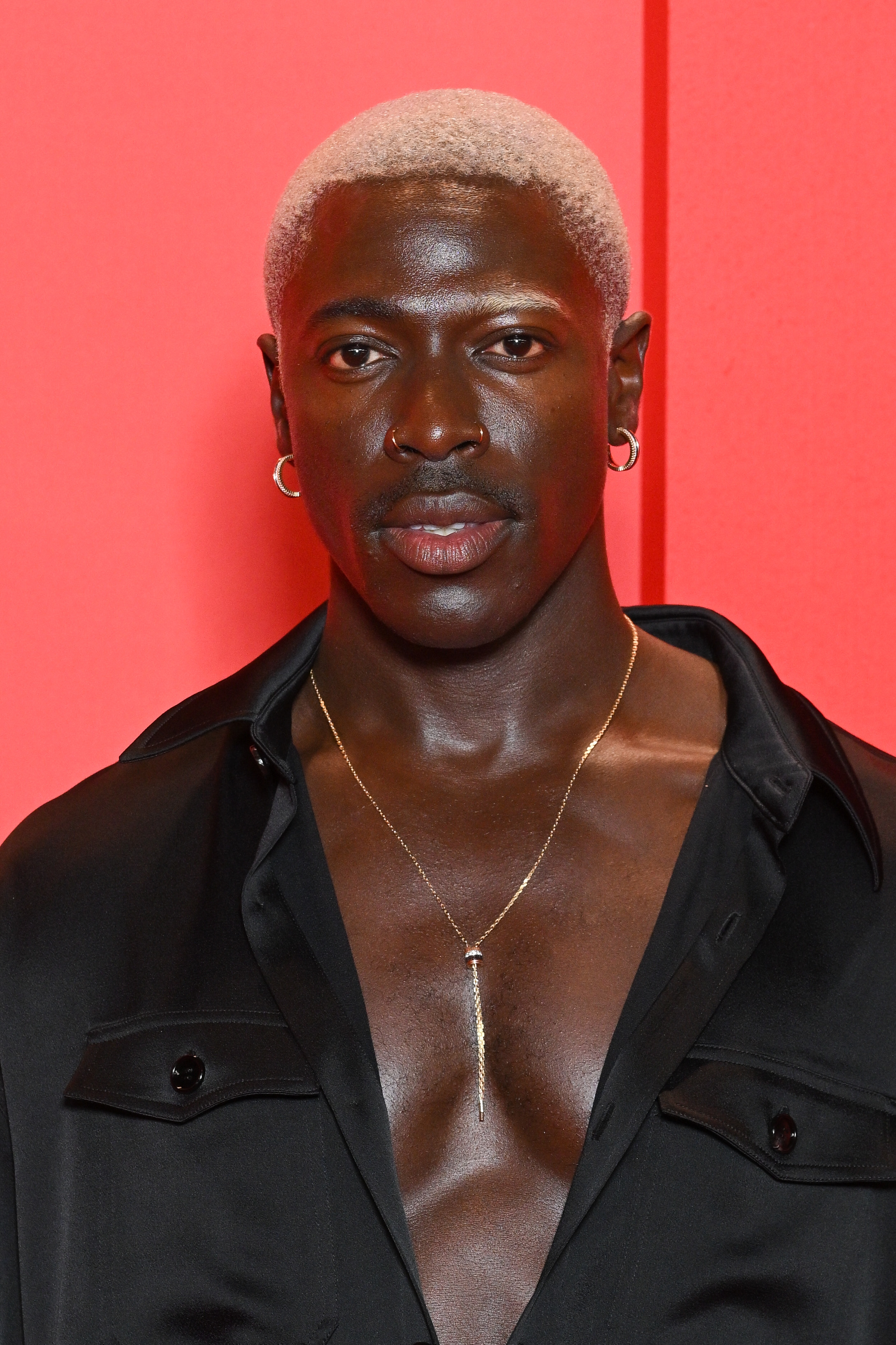 Moses Sumney wearing a button-up shirt with his chest partially exposed at the premiere of "The Idol"