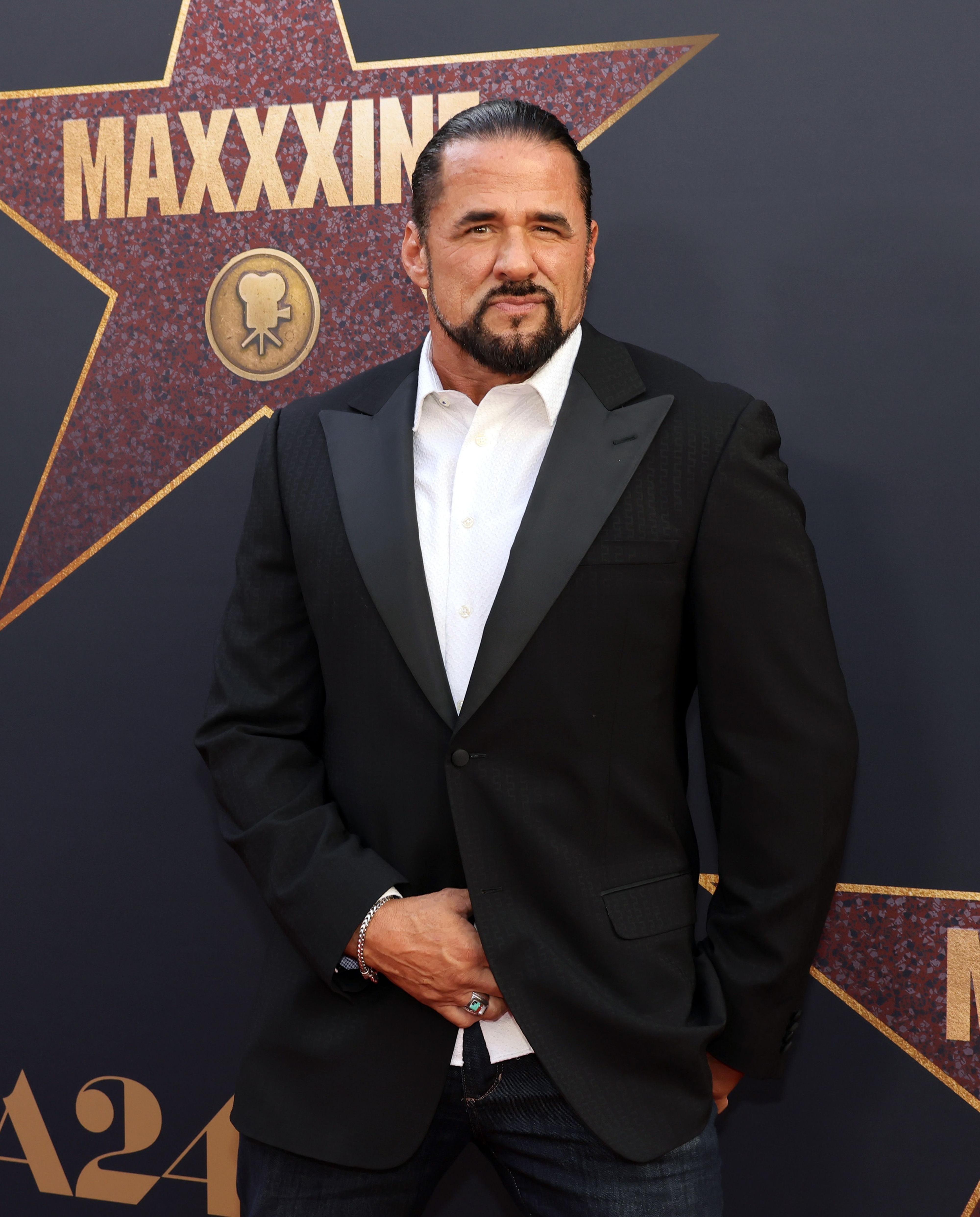 Marcus LaVoi in a suit and tie at the premiere of "MaXXXine"