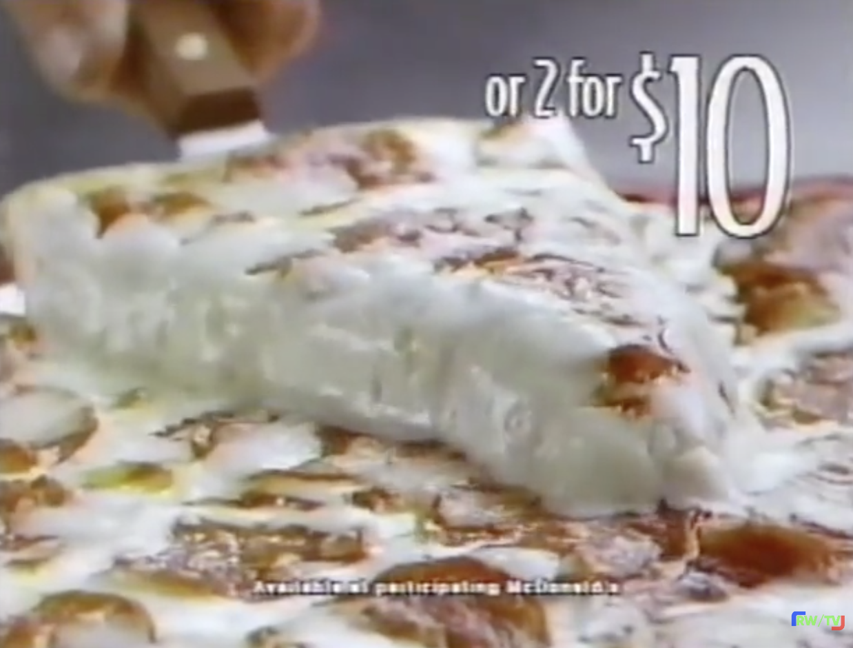 A slice of pizza being lifted, with text displaying "or 2 for $10." Available at participating McDonald's is noted below