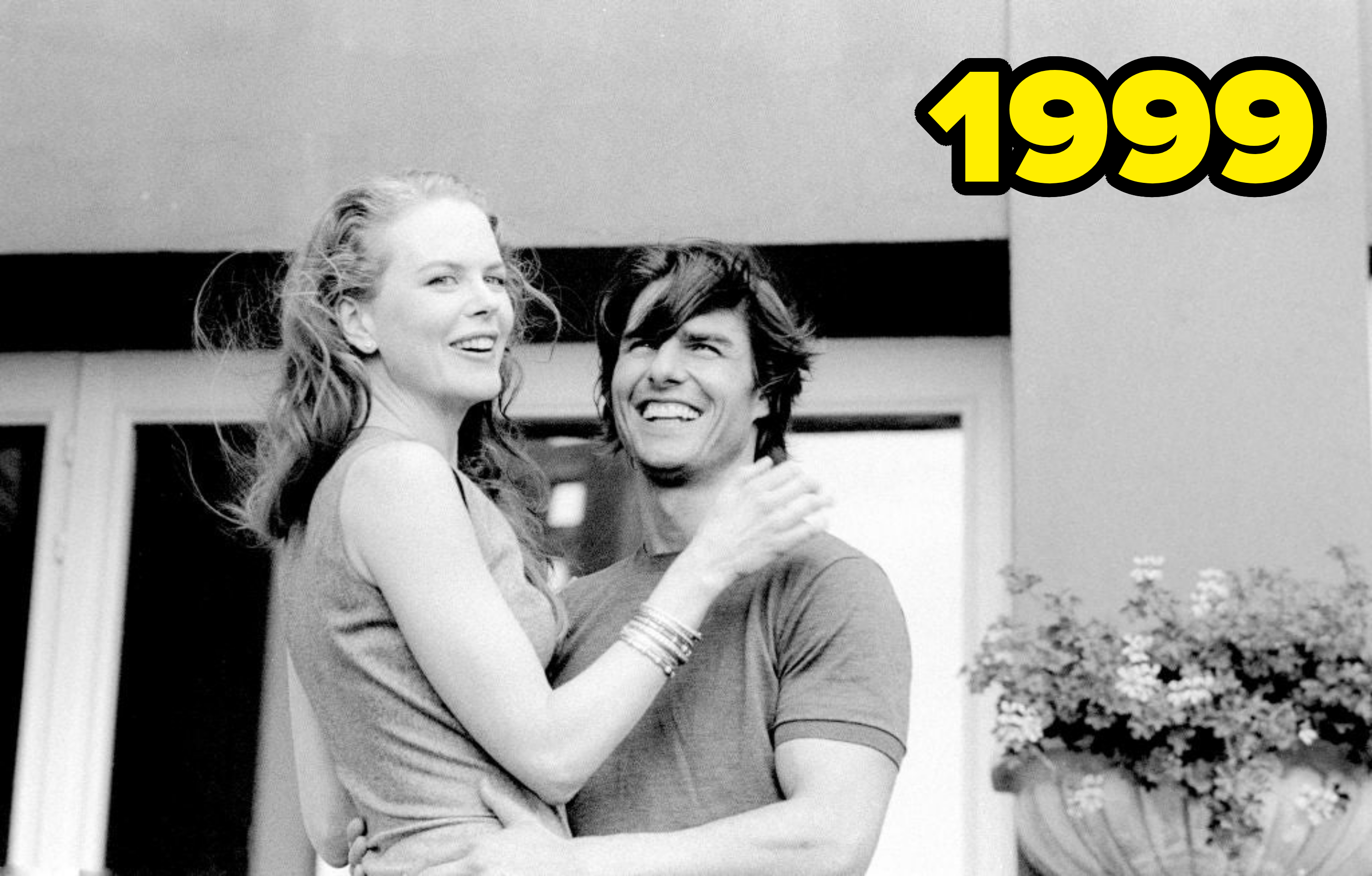 Nicole Kidman and Tom Cruise smiling and embracing outside a building