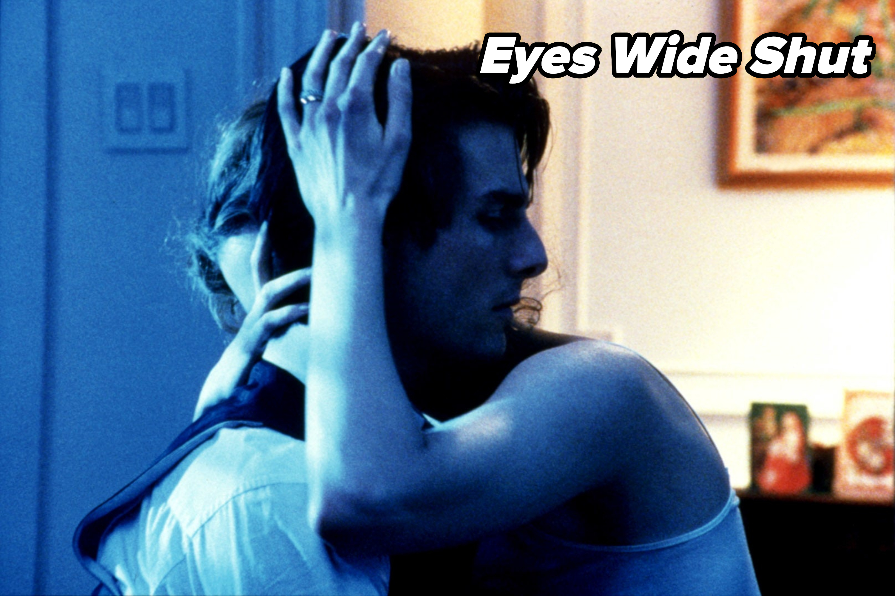 I don't know who the individuals are in this image. Two people embracing, one with a hand on the other's head, in a dimly lit room
